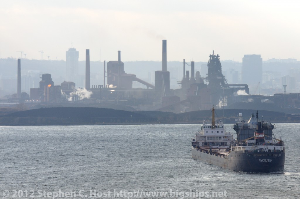 Algosteel has just entered the Burlington Bay - with a cargo of Iron Ore from the Labrador iron ore fields. The ship is turning to dock at the Steel Mills of Hamilton shown in the background.