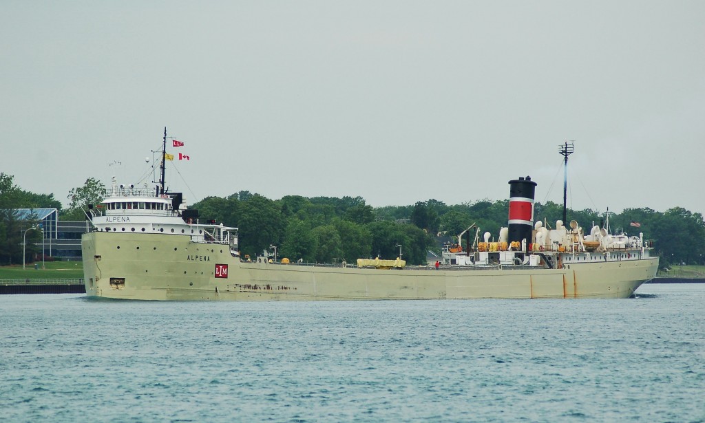 Under storm clouds Inland Lakes Management's "Alpena" passes by Sarnia downbound and loaded in the St. Clair river. The Alpena makes a few trips a year through here and it a rare sight in these parts, her short length, cargo's of cement and steam power drive make it a unique catch. This is the only ship still sailing for Inland Lakes Management, the rest have been in layup as cement storage barges.