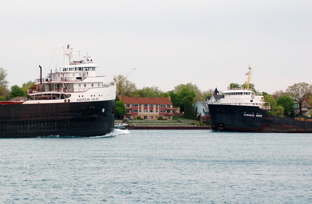 American Valour passes down bound in the St. Clair river in Sarnia as it meets up bound Canadian Miner of the then Upper Lakes fleet. American Valour was formerly Armco of Ogelbay Norton fleet but sold to American Steamship in 2006. Both ships last sailed in 2008 with the American Valour in long term layup and the Miner sold for scrap.