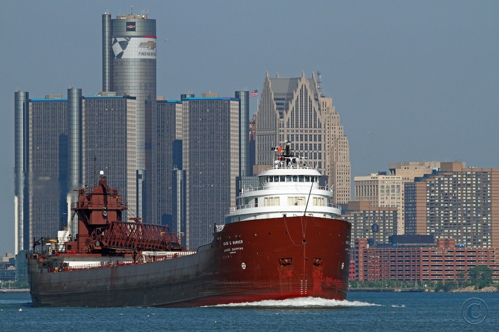 While the wrap on GM's World Headquarters says "FIND NEW ROADS", the Kaye E. Barker follows a familiar path as she heads upbound on the Detroit River to load taconite in Marquette.